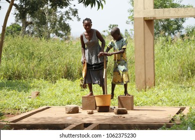 Dangbo Benin November 17 2015  Girls Pumping Water From The Well