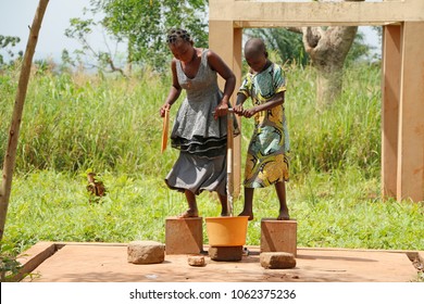 Dangbo Benin November 17 2015  Girls Pumping Water From The Well