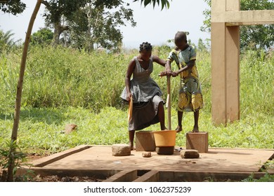 Dangbo Benin November 17 2015  Girls Pumping Water From The Well