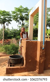 Dangbo Benin November 17 2015  Woman Stands At A Water Well To Take Water