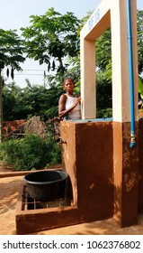 Dangbo Benin November 17 2015  Woman Stands At A Water Well To Take Water