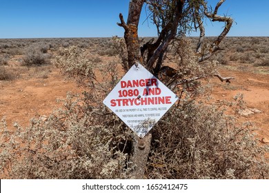 Danger 1080 And Strychnine Sign On The Tree In Desert. Australia.