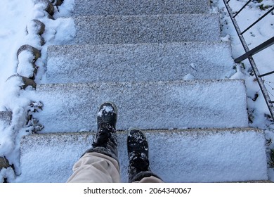 Danger of accident on snow-covered slippery steps of stairs in winter