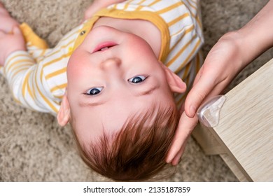 Danger for baby hit the corner of the table. Protect children from home furniture, kids safety - Shutterstock ID 2135187859