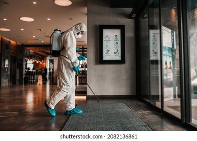 The Danger Of Corona. A Man In Protective Clothing Prevents The Spread Of The Infection In A Respectable Hotel. Stay Healthy, COVID19 Alert