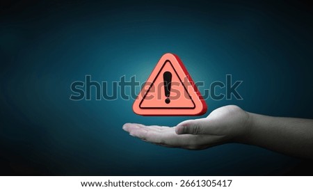 Danger and error alert concept. Notification red triangle warning symbol on human hand. Maintenance of security systems, and sensitive data protection.