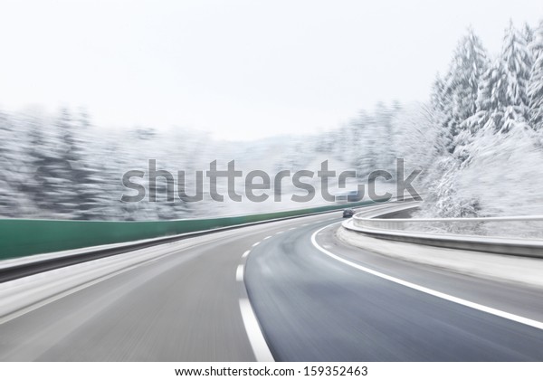 Danger and fast turn at the icy snow\
road. Motion blur visualizies the speed and\
dynamics.