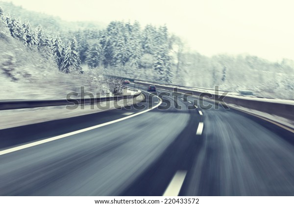 Danger and fast turn at the icy snow\
road. Motion blur visualizies the speed and\
dynamics.
