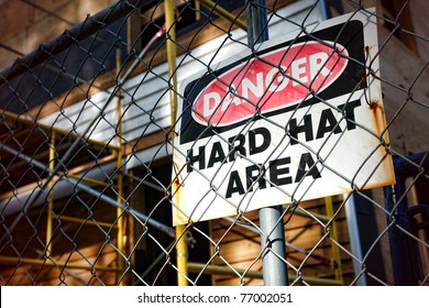 Danger Hard Hat Area Safety Warning Sign On A Chain Link Fence At A House Construction Work Site