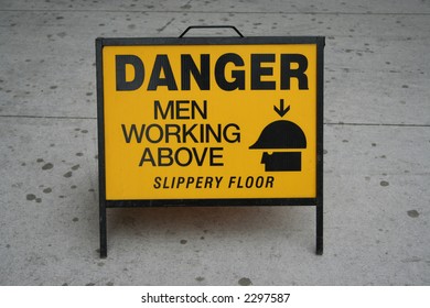 Danger men working above sign