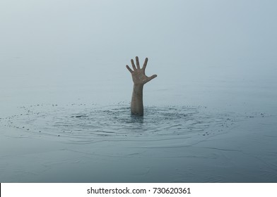 Danger, problems, risk concept. Close up of human hand drowning in the lake