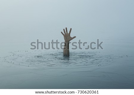 Danger, problems, risk concept. Close up of human hand drowning in the lake