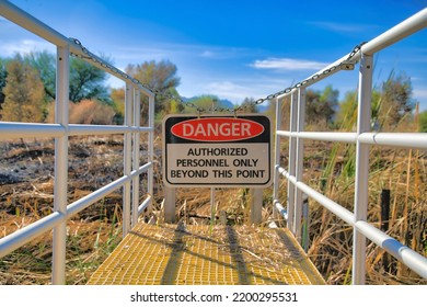 Danger Sign At A Boardwalk In Sweetwater Wetlands Park In Tucson Arizona. Nature Preserve Landscape With Warning Signage At An Area Off Limits To Tourists.