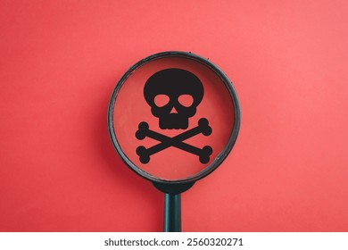 Danger Signs, Toxicity, Chemical Warnings, Risk Indicators, Cyber Threats, Gaming Symbols concept.,Magnifying glass focus on skull icon over red background.