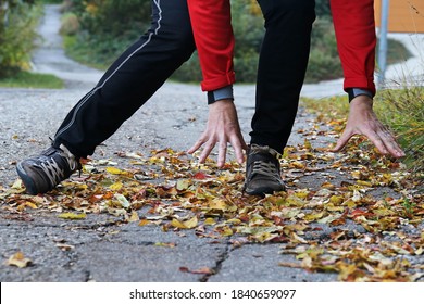 Danger Of Slipping In Autumn And Winter. A Woman Slipped On Wet, Smooth Leaves