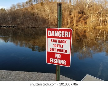 Danger Stay Back Deep Water No Fishing Sign Near Water