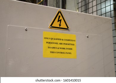 Danger symbol industrial sign with warning symbo for electrocution electricity on control panel casing in yellow