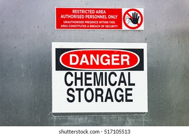 Danger Warning Sign For Chemical Storage In Restricted Area.
English Language Danger Chemical Storage Warning Sign Labels On Large Steel Wall