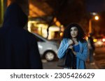Danger, woman fear and criminal in the city at night with thief and anxiety outdoor, Urban, dark and female person feeling scared with stress and terror from stalker, crime and risk of scary violence