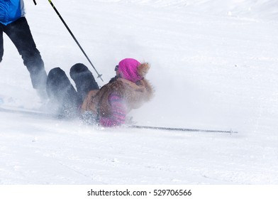 Dangerous Accident: The Collision And Fall Of Skiers. Woman Lying In The Snow At Her Ski Pole Is Directed.