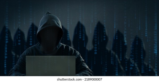 Dangerous Anonymous Hackers Are Using Laptops For Identity Theft, Internet, Cybercrime. Cyber Attack, Destruction And Malware Concept. Blackout. Digital Binary Code On Background.