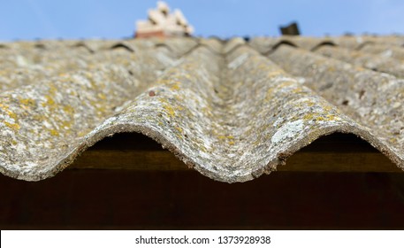 Dangerous asbestos roof. Asbestos dust in the environment. Health problems