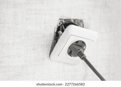 Dangerous bad,broken socket,plug in bathroom,falling out of wall. Outlet installation in old apartment. Poor electrical wire,repair.Terrible do-it-yourself repairmen.Short circuit risk,electric shock.