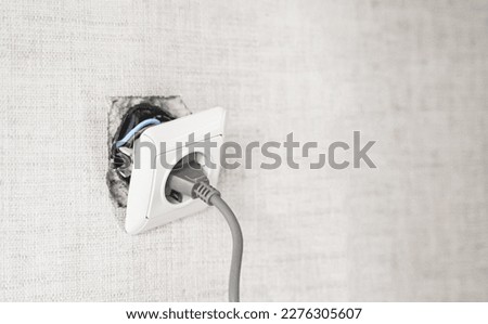 Dangerous bad,broken socket,plug in bathroom,falling out of wall. Outlet installation in old apartment. Poor electrical wire,repair.Terrible do-it-yourself repairmen.Short circuit risk,electric shock.