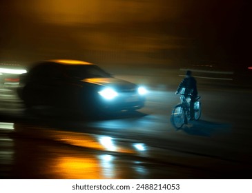 Dangerous city traffic situation with cyclist and car in the city at night in motion blur - Powered by Shutterstock