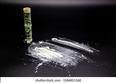 The Dangerous Cocaine With One Dollar. Heroine On Black Background. 