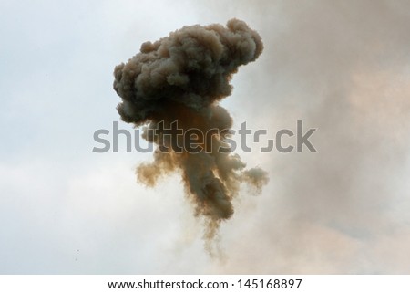 dangerous and dramatic cloud of black smoke after an explosion in the sky