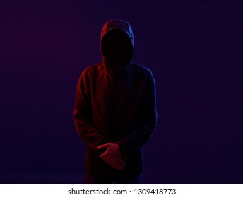 Dangerous hooded hacker. Internet, cyber crime, cyber attack, system breaking and malware concept. Dark face. Anonymous.