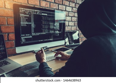 Dangerous Hooded Hacker Using Credit Card Typing Bad Data Into Computer Online System And Spreading To Global Stolen Personal Information. Cyber Security Concept