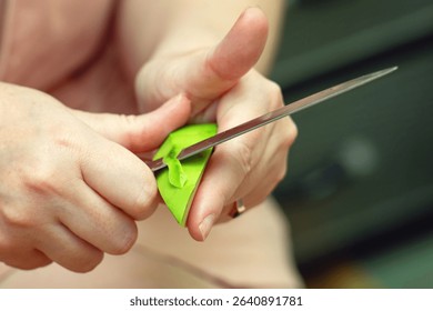 Dangerous knife technique while peeling an avocado, showing risky food preparation that could cause injury.