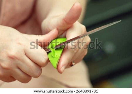 Dangerous knife technique while peeling an avocado, showing risky food preparation that could cause injury.