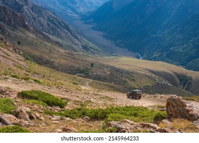 Dangerous Mountain Gravel Road With Off-road UAZ Descending In Mountain Valley. Summer Road Trip, Journey. Way To Burkhan-Bulak Waterfall. Kapalskiy Vzvoz Mountain Pass.  29.08.2021 Kapal, Kazakhstan.