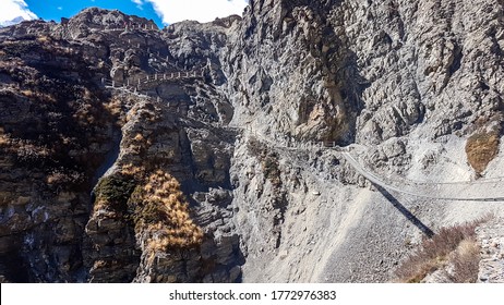 A Dangerous Passage With Suspensions Bridges And Ladders On The Way To Tilicho Base Camp, Annapurna Circus, Himalayas, Nepal. Dry And Desolated Landscape. Steep And Sharp Slopes. Extreme Trekking