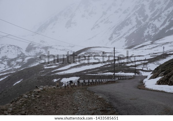 Dangerous road in the mountains. High Mountain\
Pass. Bad weather.