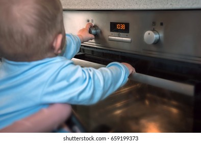 Dangerous Situation, The Child Is Playing With An Electric Stove. The Child Plays Near A Hot Stove.