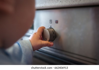 Dangerous Situation, The Child Is Playing With An Electric Stove. The Child Plays Near A Hot Stove.