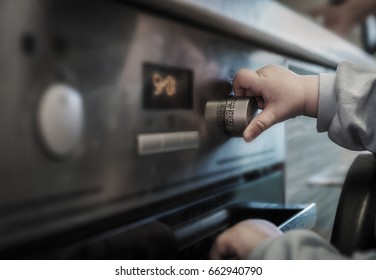 Dangerous Situation, The Child Is Playing With An Electric Stove. The Child Plays Near A Hot Stove.