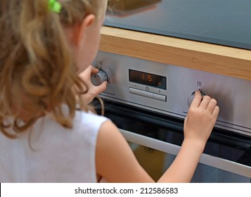 Dangerous situation in the kitchen. Child playing with electric oven.
