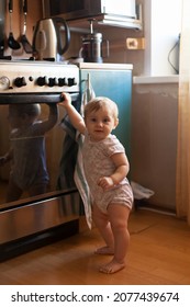    Dangerous Situation With   Small Child And   Hot Stove In   Kitchen. 