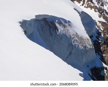 Dangerous Snow Ledge On The Top Of The Mountain. Ledges From The Snowy Mountains. Cliffs And Large Rocks. Dangerous Terrain. 