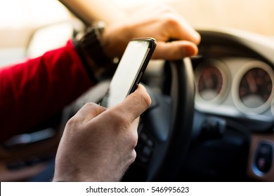 Dangerous texting and driving at the same time - Shutterstock ID 546995623