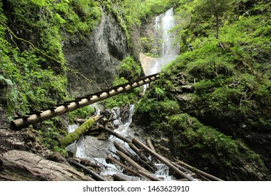 Dangerous trail through a waterfall with wooden ladders in the Slovak Paradise National Park, Slovaki