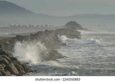 Dangerous waves hit and splash a jetty in California  - Shutterstock ID 2243350883