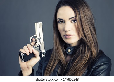Dangerous woman holding up her gun