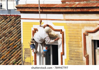 Dangerous Work, Painter Of Facades In Height Painting A House In Yellow