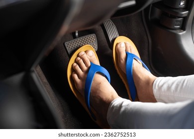 The Dangers of Wearing Sandals While Driving, young woman wearing sandals while driving, breaking the law, car accident, carelessness while driving